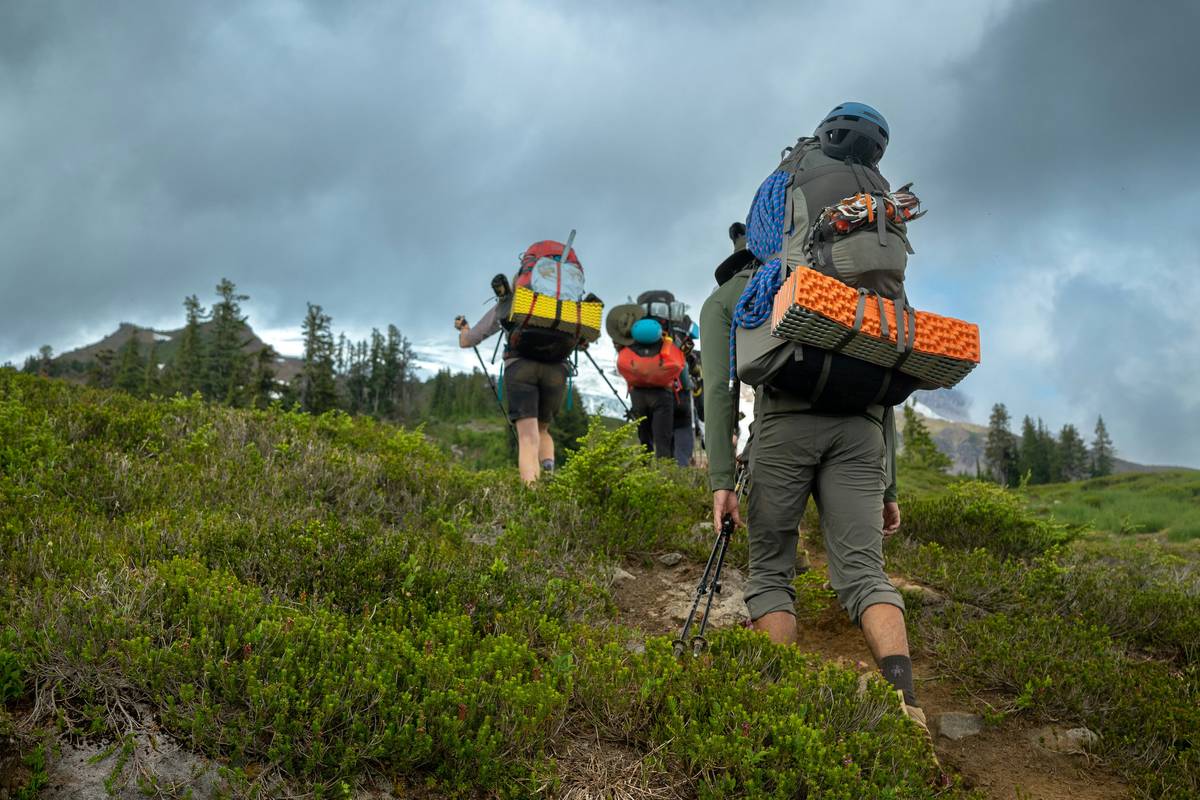 Canadian wilderness trainer demonstrating load-bearing hike during outdoor guide training canada