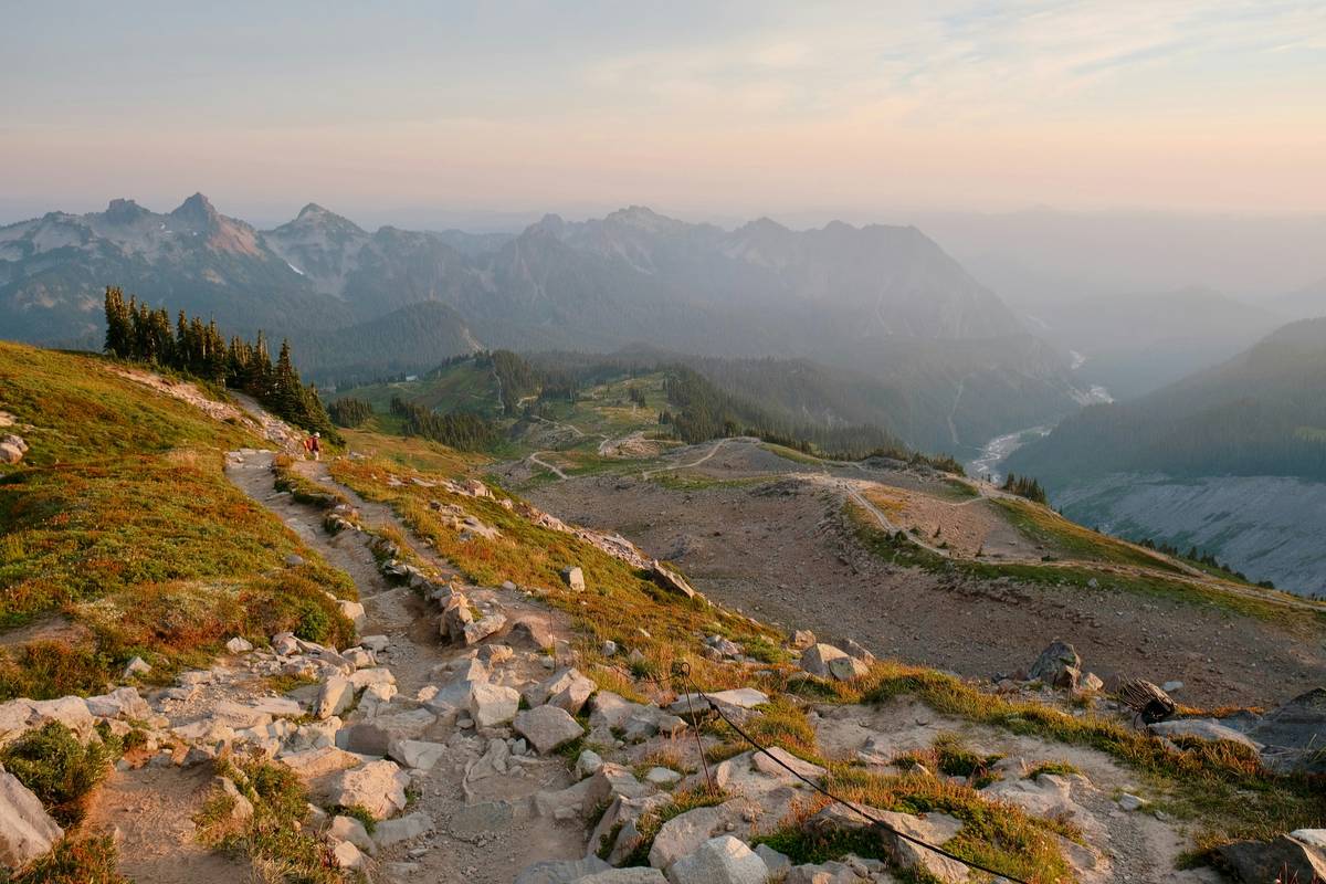 Man doing push-ups on a rocky trail showcasing physical health benefits of outdoor exercise